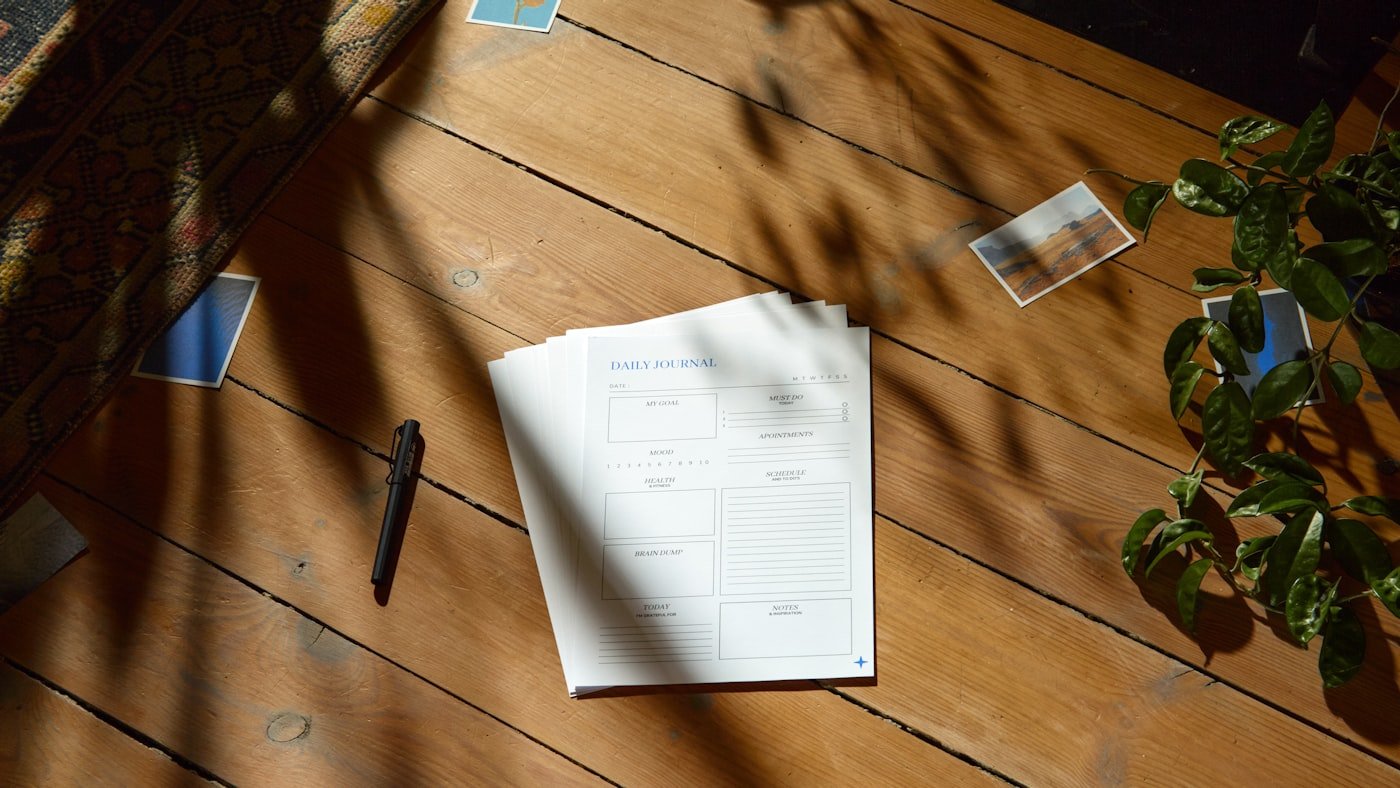 A desk with a notebook and a telephone in daylight