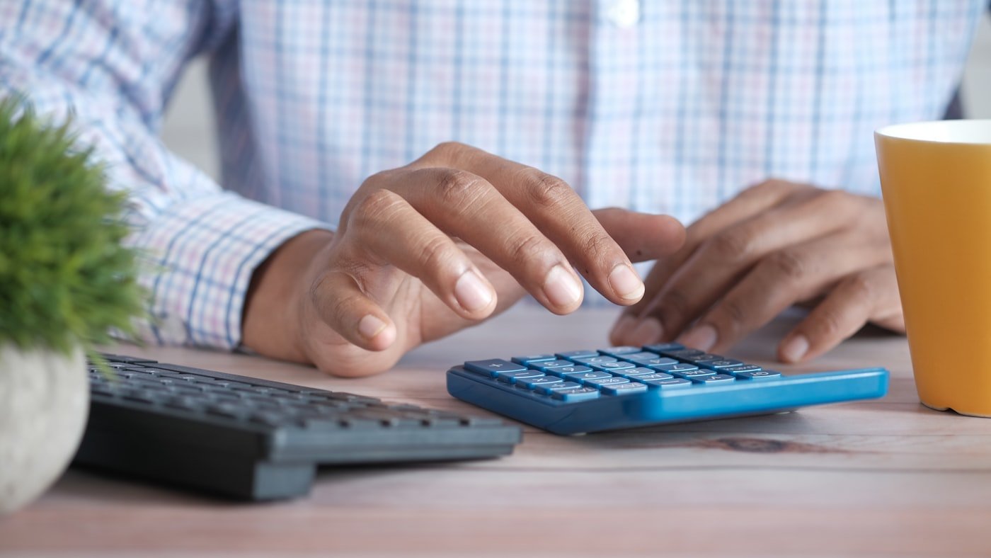 Hands working through figures on a calculator